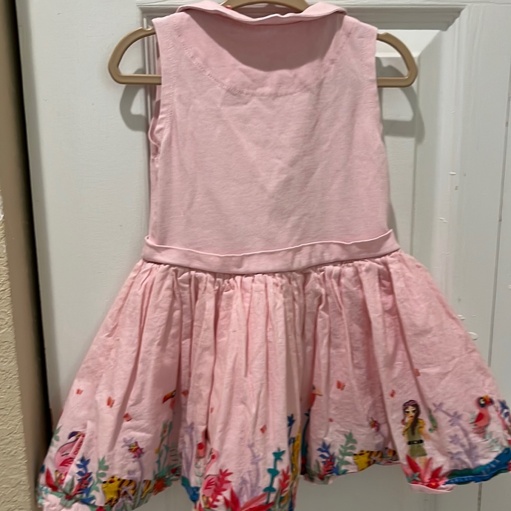 Light pink dress with animals at the bottom.